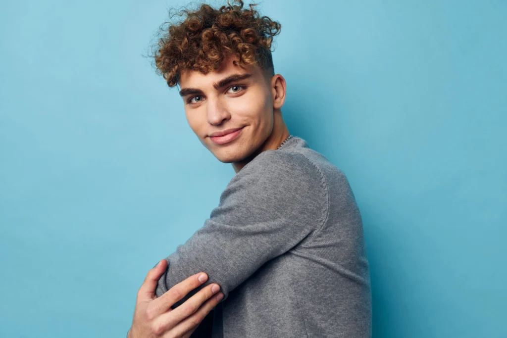 Attractive young man with curly hair scaled 1